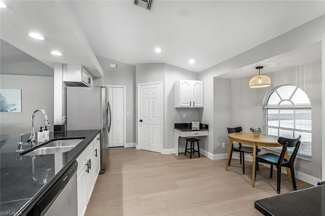 a large kitchen with a table and chairs
