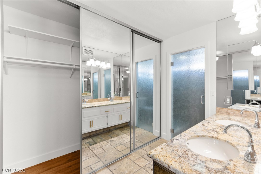 4430 Cranbrook Way Las Vegas, NV 89103 - Photo 39 of 50 Granite counters and dual sinks define this elegant bathroom, complemented by spacious mirrored closets.