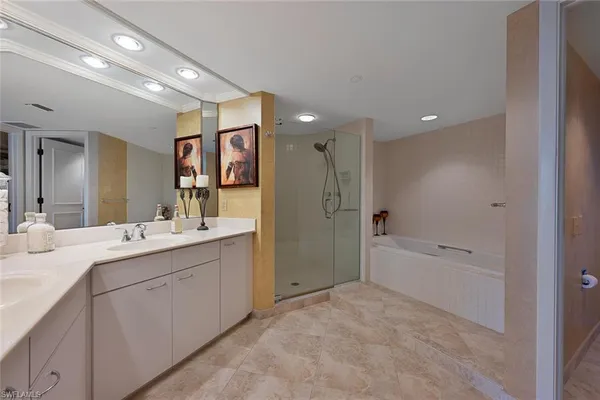 a bathroom with a bathtub shower sink and mirror