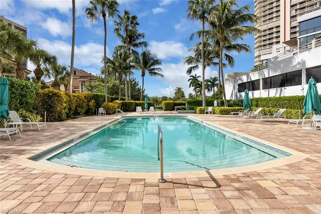 a view of a swimming pool with a lounge chairs