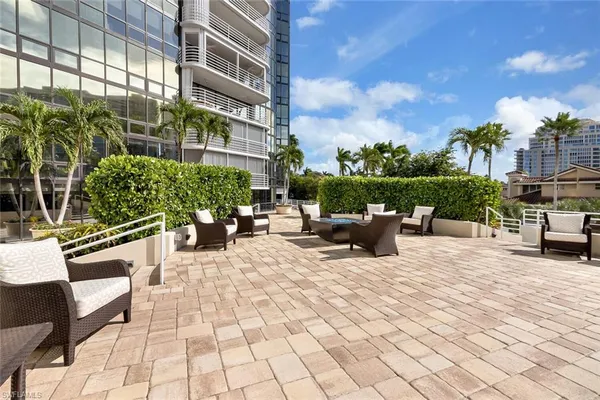 a view of a patio with couches and potted plants