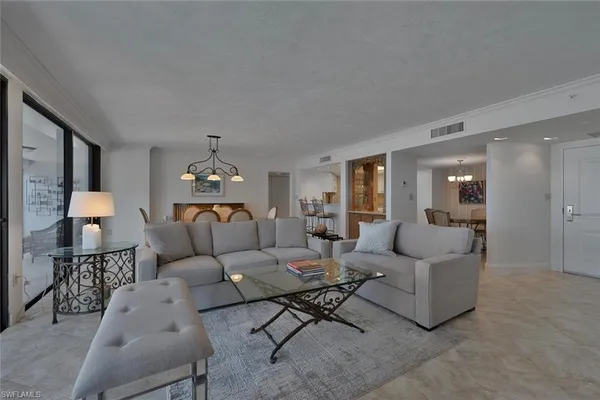 a living room with furniture and a chandelier