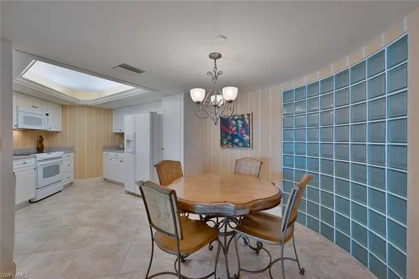 a view of a dining room with furniture and a chandelier