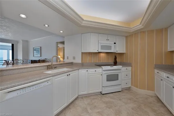 a kitchen with cabinets a sink and appliances