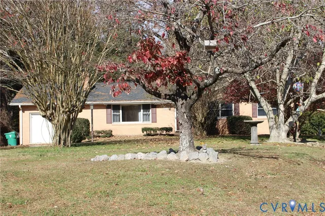 a front view of a house with a yard covered with snow