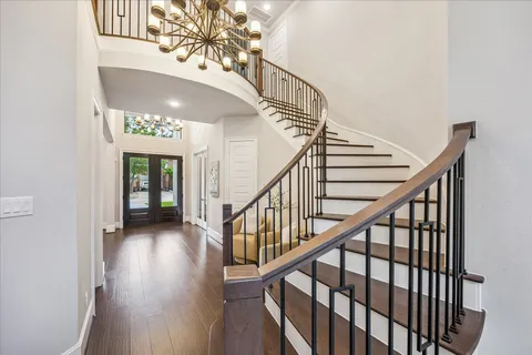a view of entryway and hall with wooden floor