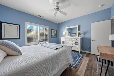 a bedroom with a bed furniture and a large window