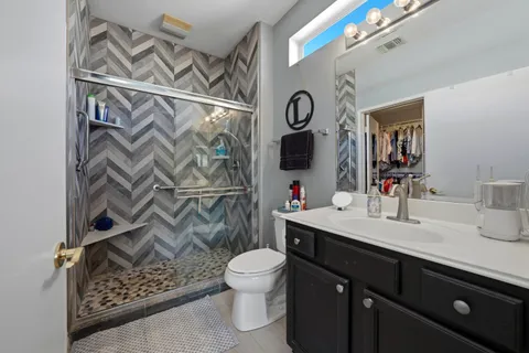 a bathroom with a sink vanity mirror and toilet