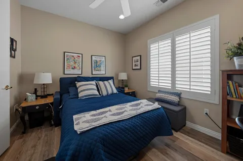 a bedroom with a bed and a large window