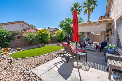a view of a patio with a table and chairs
