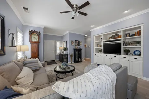 a living room with furniture fireplace and a flat screen tv