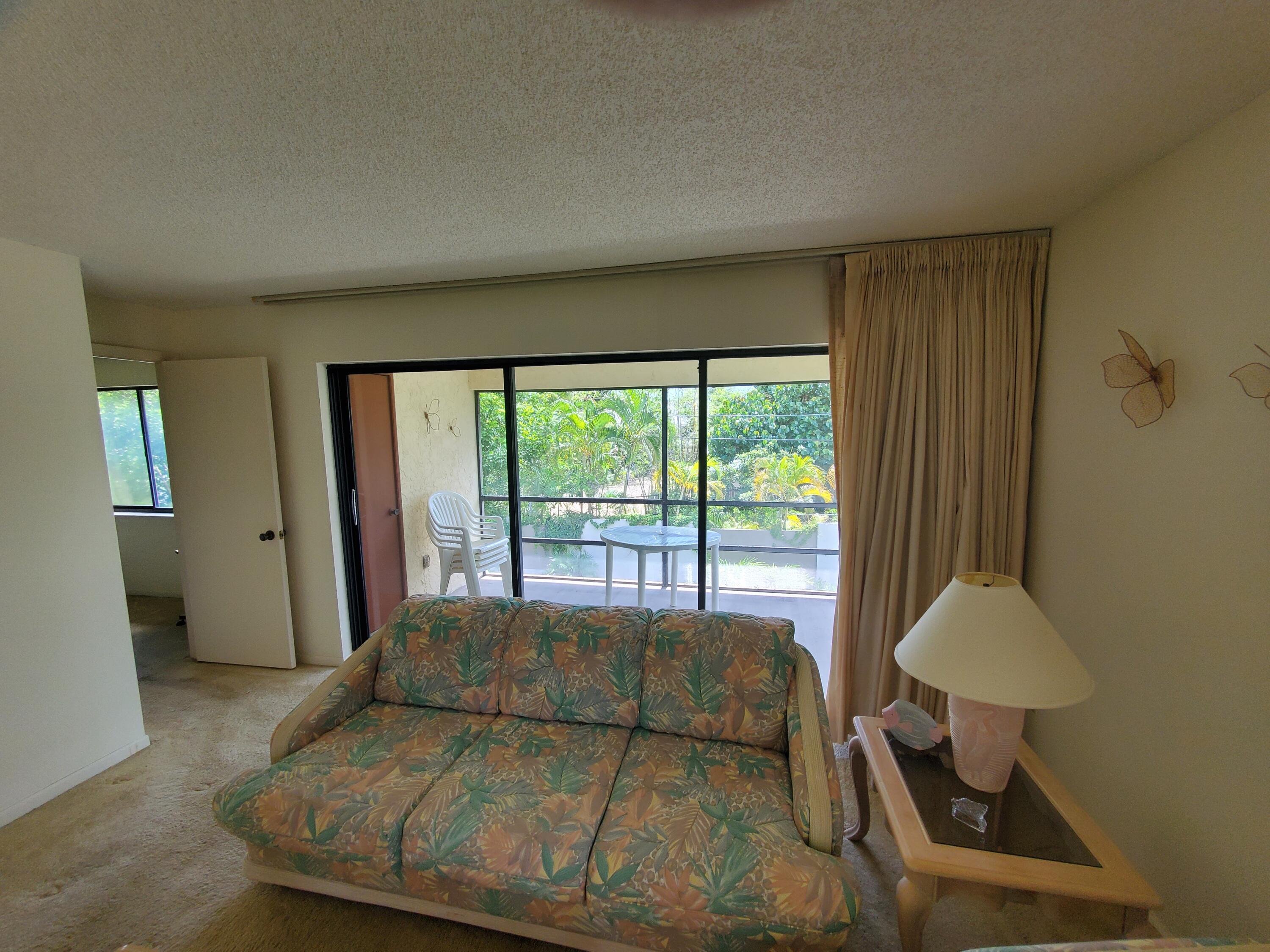 1600 Northeast Dixie Highway, Unit 9206 Jensen Beach, FL 34957 - Photo 12 of 33 Livingroom to Back Screened Patio