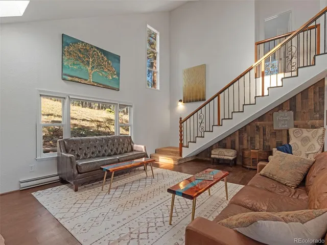 a living room with furniture a rug and a fireplace