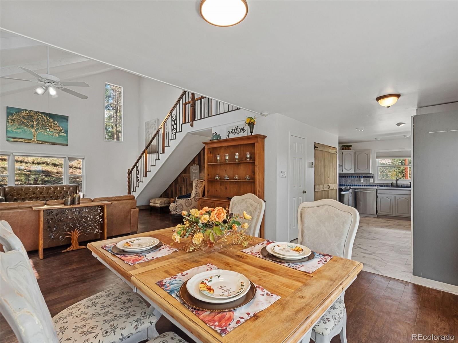 11825 South Little Turtle Lane Conifer, CO 80433 - Photo 17 of 34 a view of a dining room with furniture a rug and wooden floor