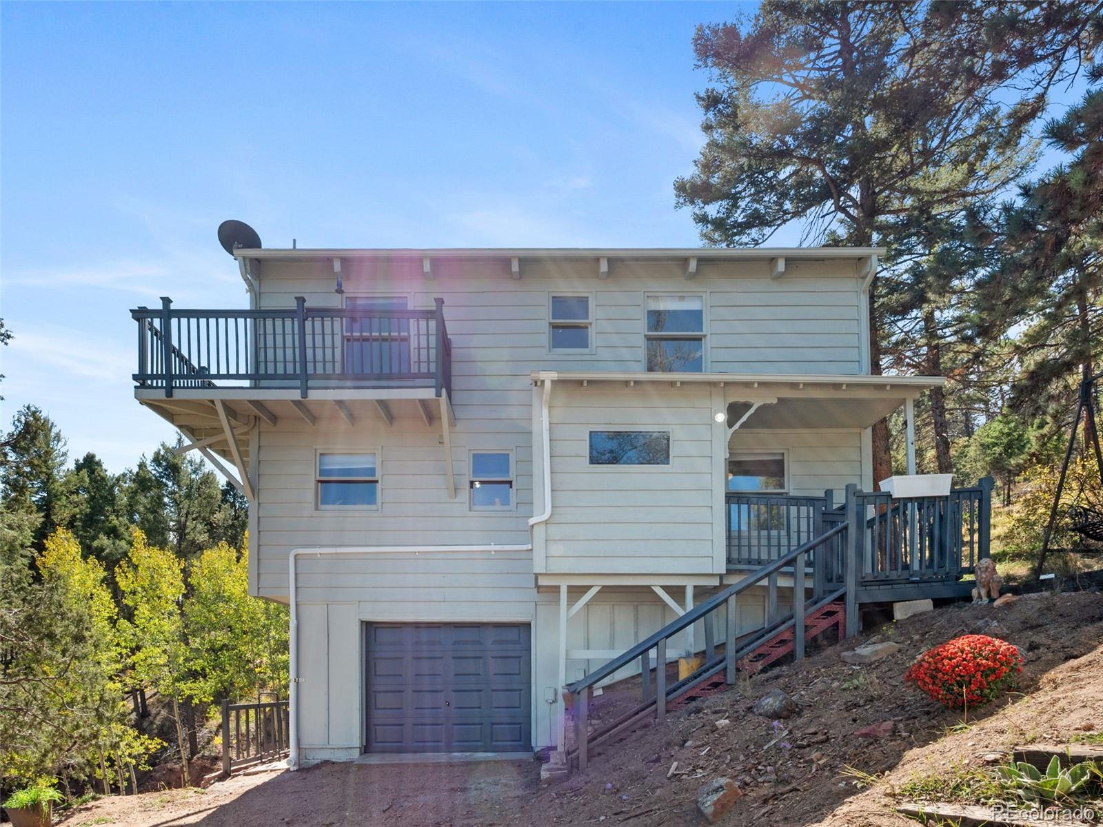 11825 South Little Turtle Lane Conifer, CO 80433 - Photo 2 of 34 a front view of a house with garden
