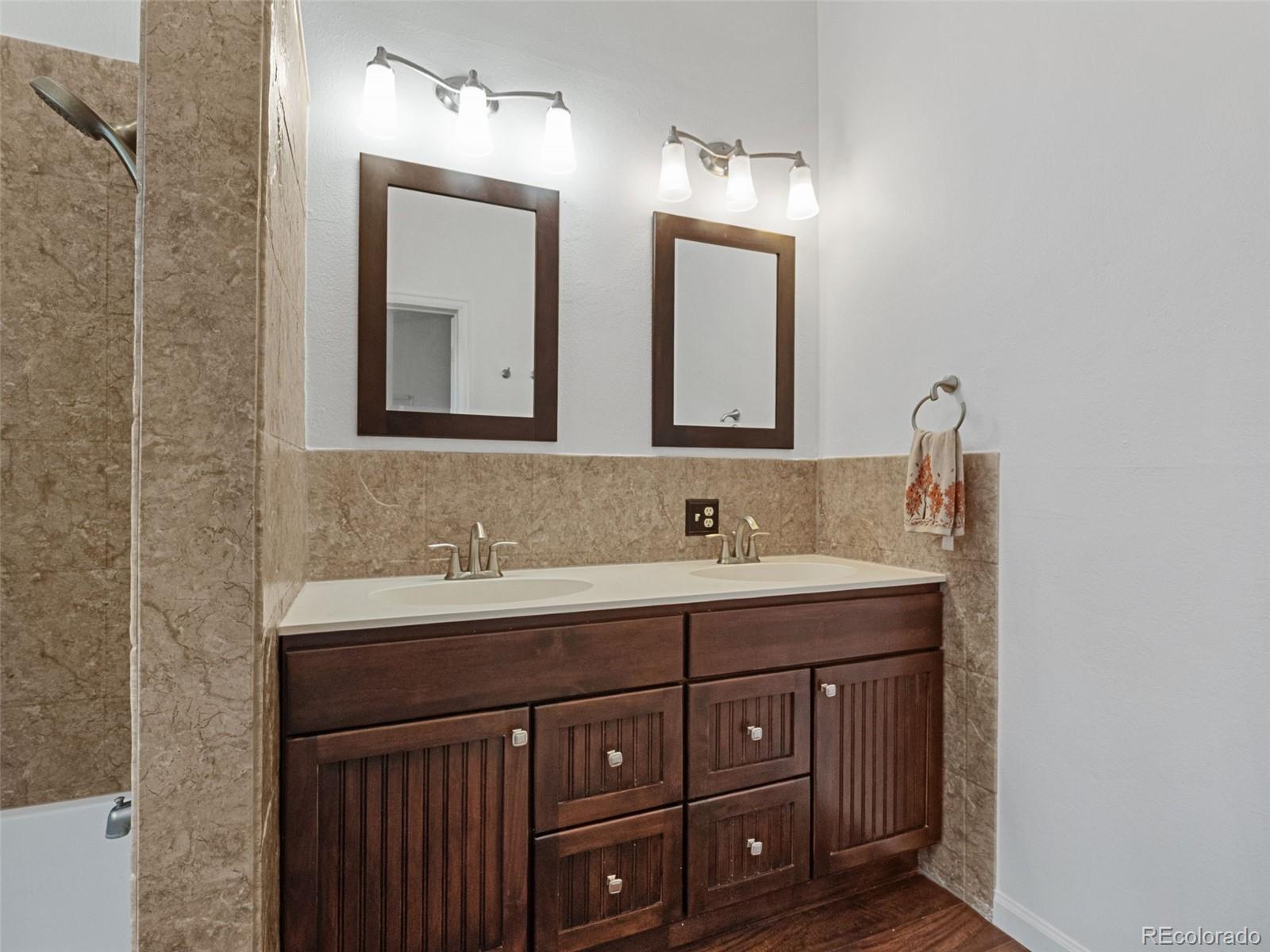 11825 South Little Turtle Lane Conifer, CO 80433 - Photo 26 of 34 a bathroom with a sink double vanity and a mirror