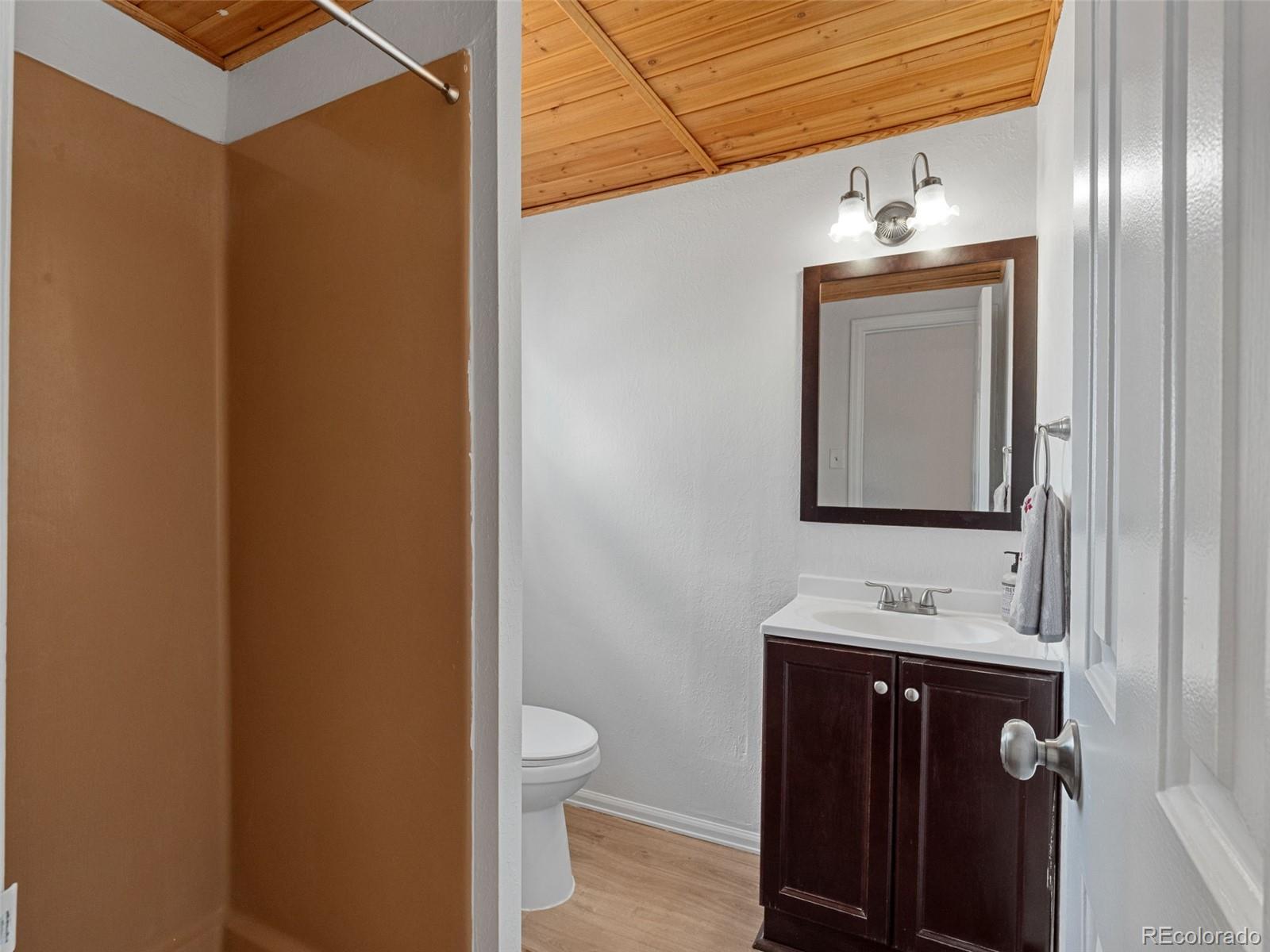 11825 South Little Turtle Lane Conifer, CO 80433 - Photo 27 of 34 a bathroom with a toilet sink and mirror