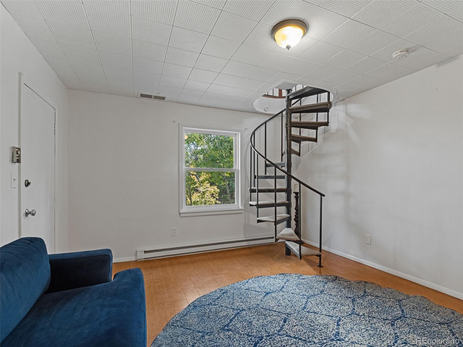 11825 South Little Turtle Lane Conifer, CO 80433 - Photo 28 of 34 a view of an empty room with a window and wooden floor