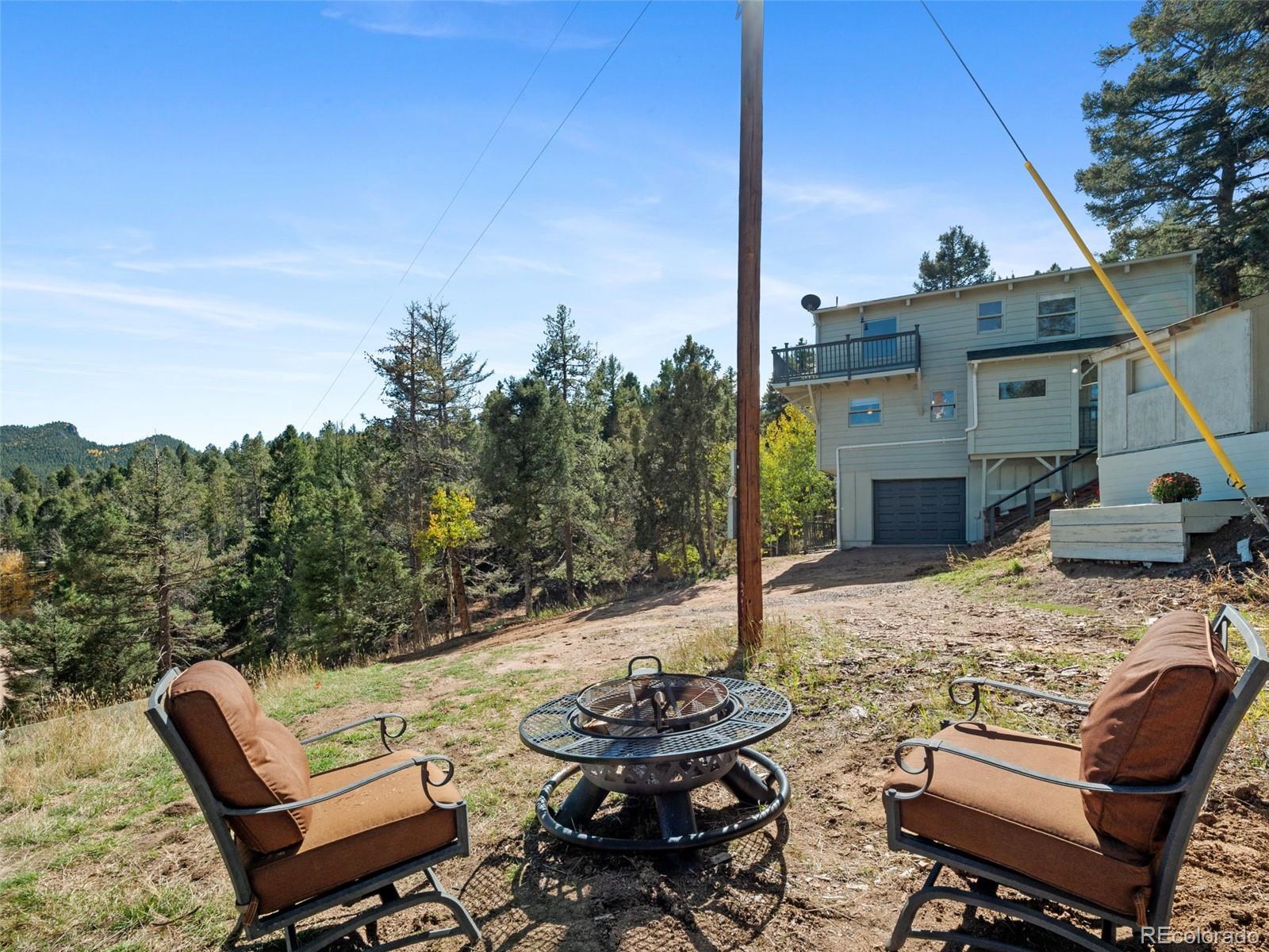 11825 South Little Turtle Lane Conifer, CO 80433 - Photo 3 of 34 a view of a patio with furniture and a fire pit
