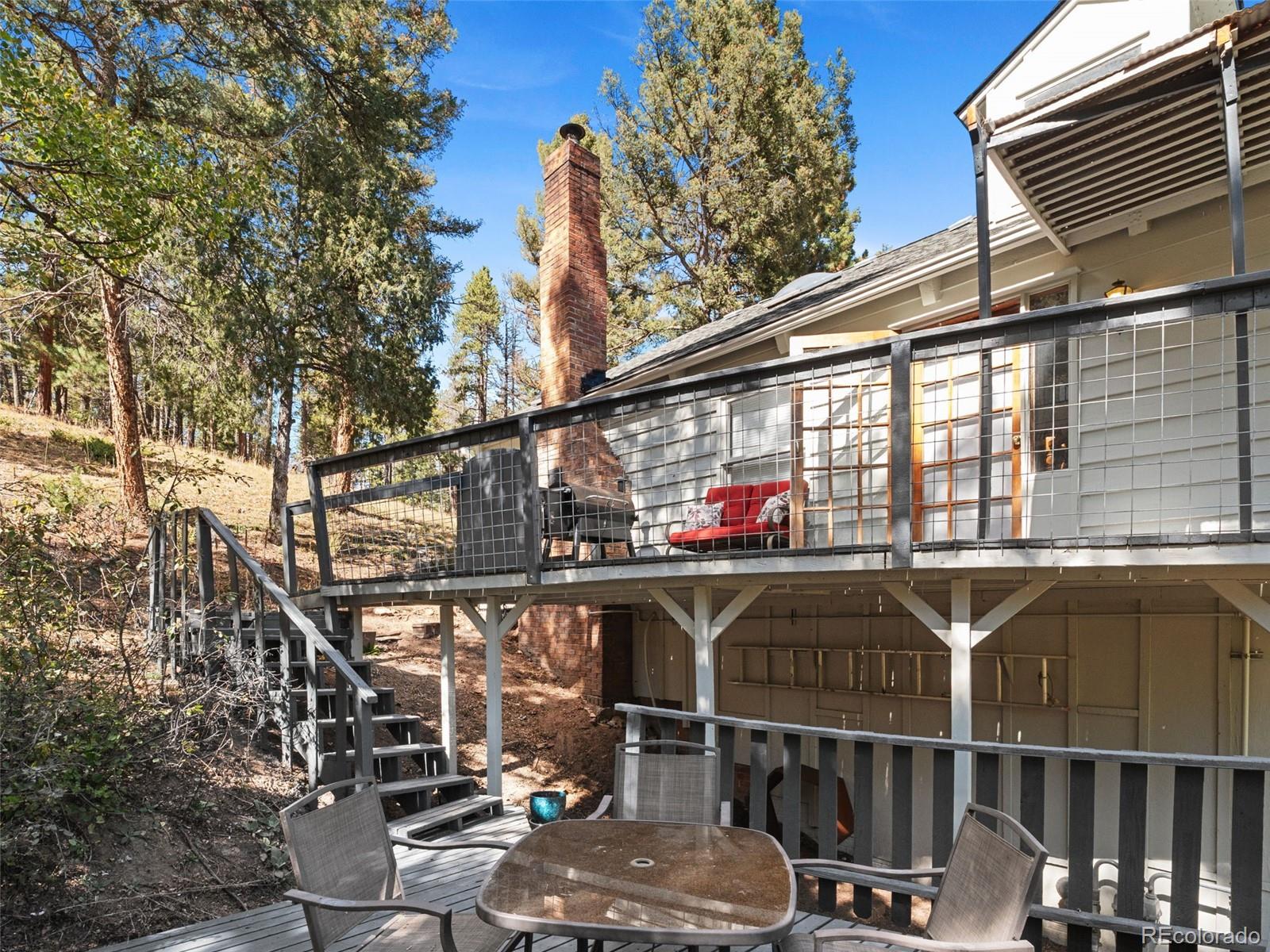 11825 South Little Turtle Lane Conifer, CO 80433 - Photo 32 of 34 a view of dinning table and chairs in patio