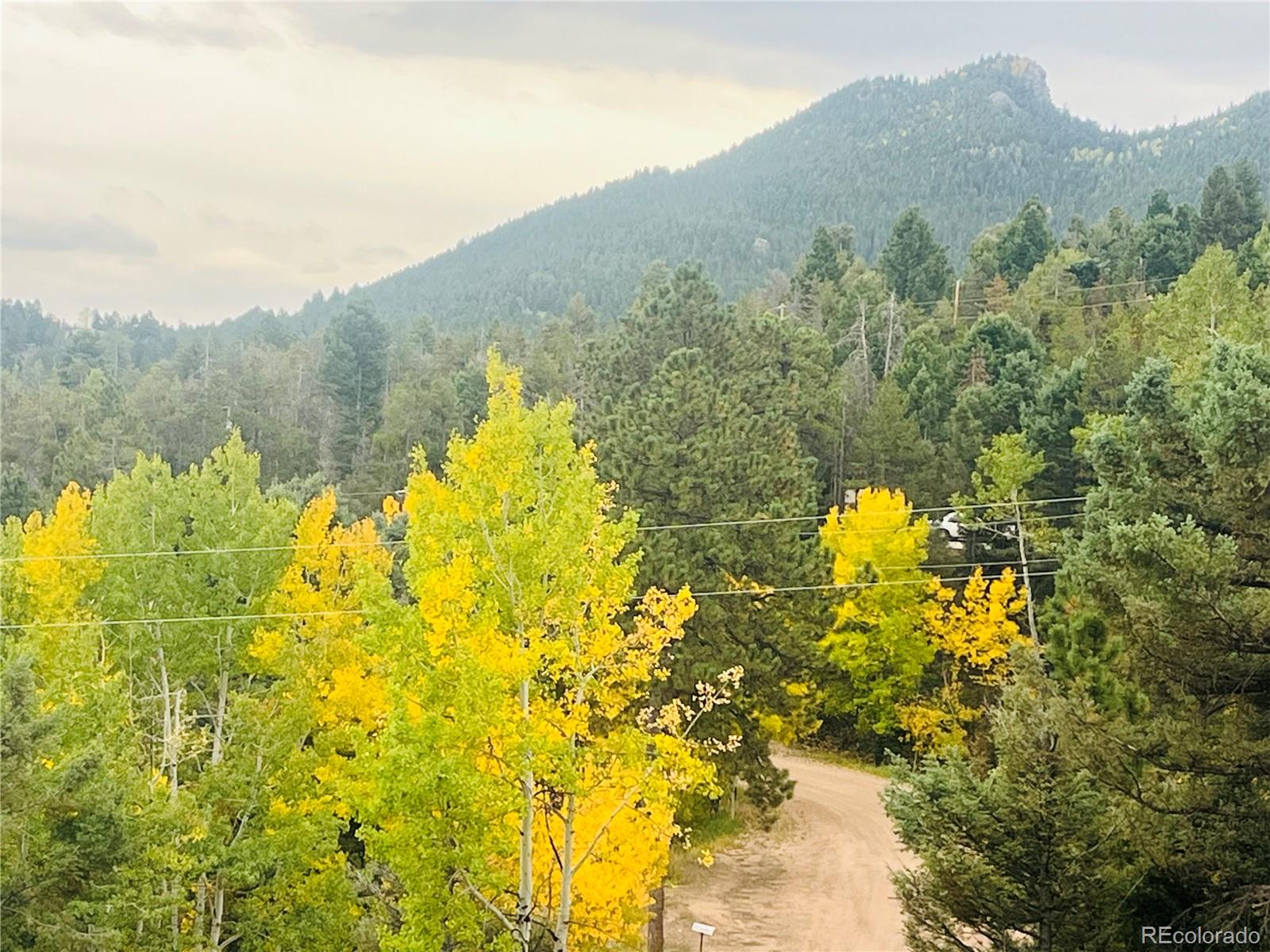11825 South Little Turtle Lane Conifer, CO 80433 - Photo 5 of 34 a view of a lake with a mountain in the background