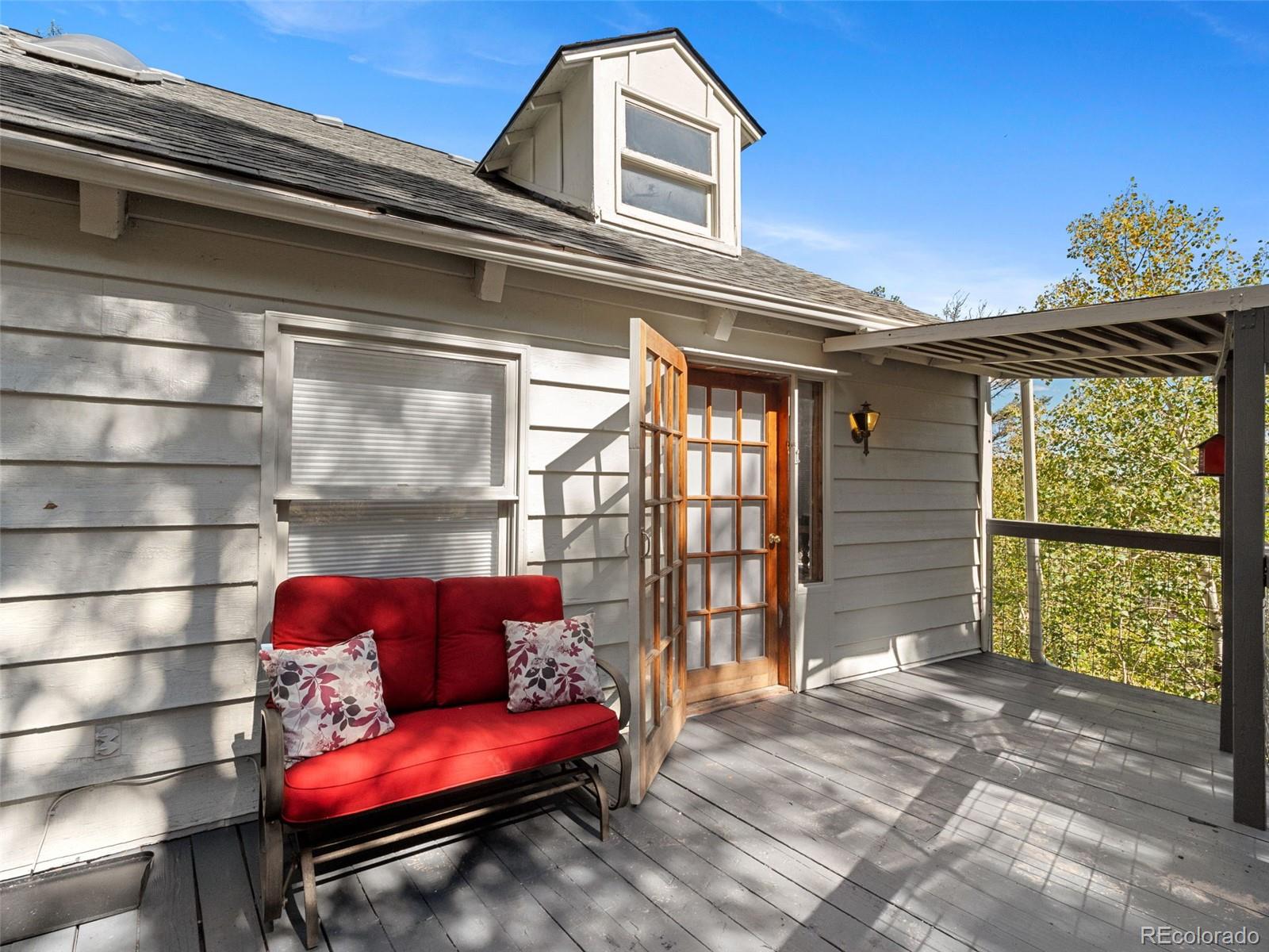 11825 South Little Turtle Lane Conifer, CO 80433 - Photo 8 of 34 a bench sitting in front of a building