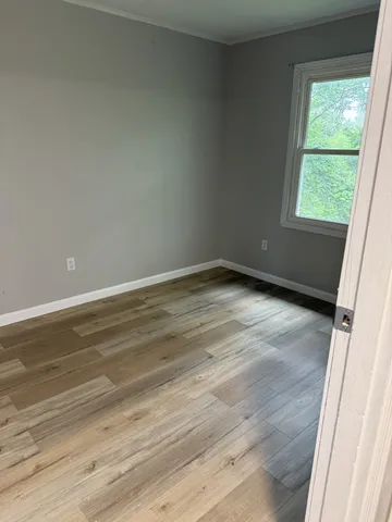 a white toilet sitting next to a bath tub
