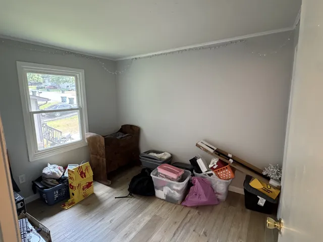 a bedroom with a bed and a chair