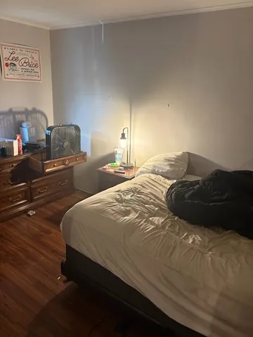 a bedroom with furniture and a wooden floor