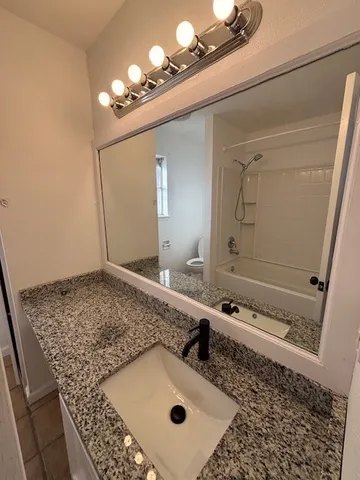 a bathroom with a sink a vanity and a mirror