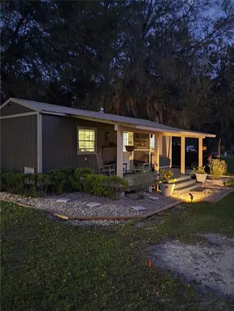 a front view of house with yard and outdoor seating