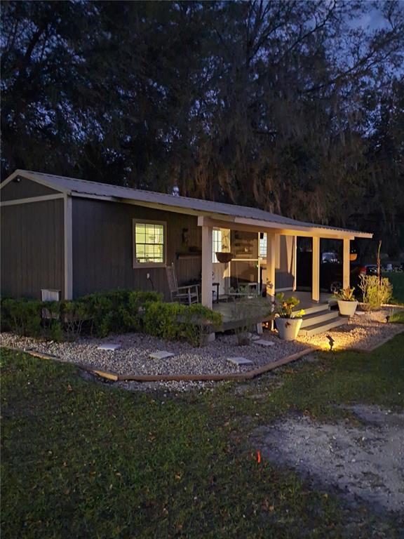 a front view of house with yard and outdoor seating