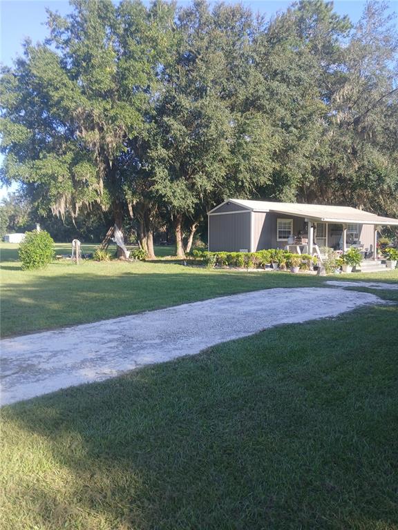 10360 County Road 18 Lake Butler, FL 32054 - Photo 2 of 43 a view of yard with green space and trees in the background