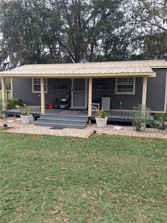 10360 County Road 18 Lake Butler, FL 32054 - Photo 37 of 43 a front view of house with outdoor seating and yard