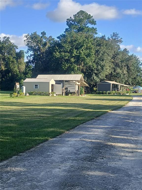 10360 County Road 18 Lake Butler, FL 32054 - Photo 4 of 43 a front view of a house and a yard