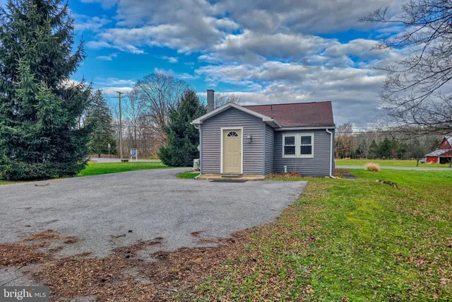 a view of a house with yard and a garden