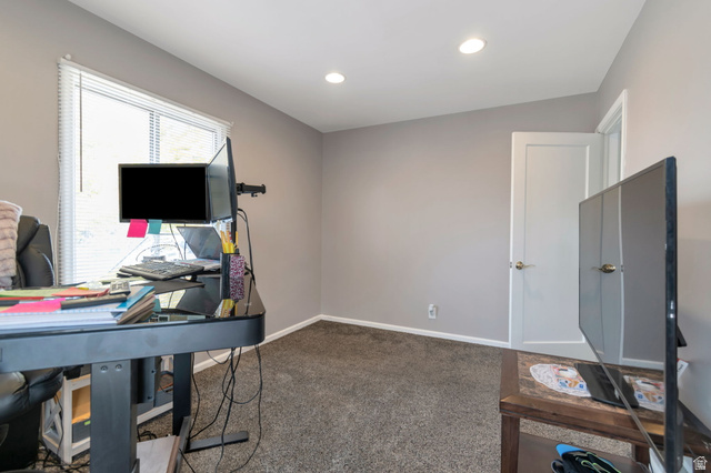7391 Elm Street Midvale, UT 84047 - Photo 30 of 38 Spacious home office featuring recessed ceiling lighting, large windows with natural light, neutral wall finishes, and carpet flooring throughout
