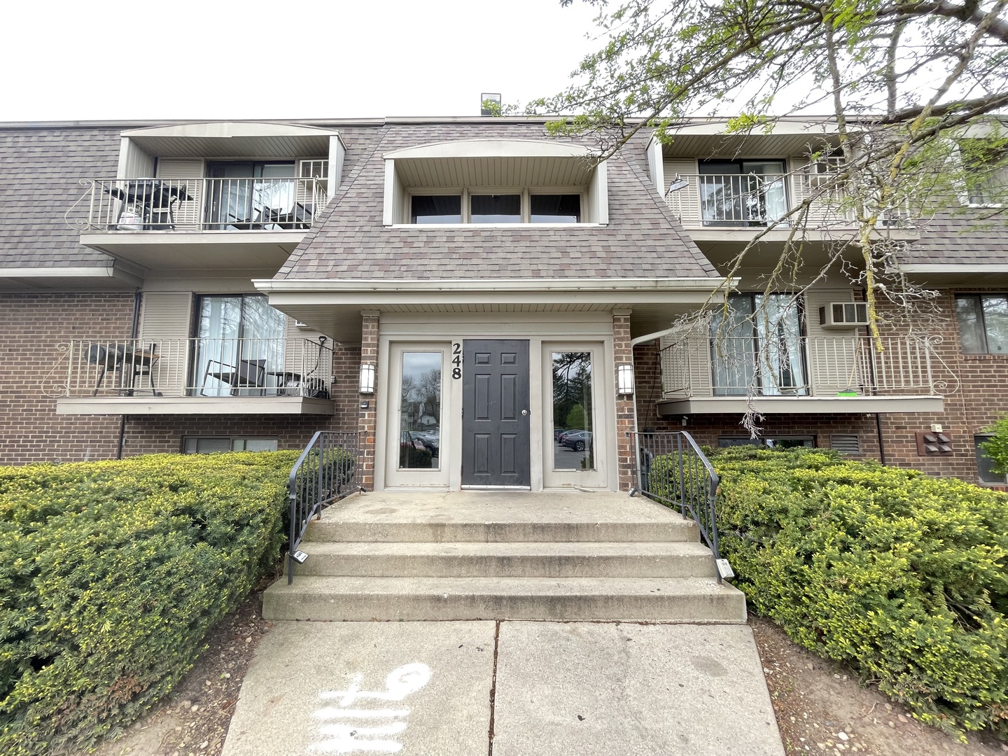 248 East Bailey Road, Unit K Naperville, IL 60565 - Photo 1 of 13 a front view of a house with a garden