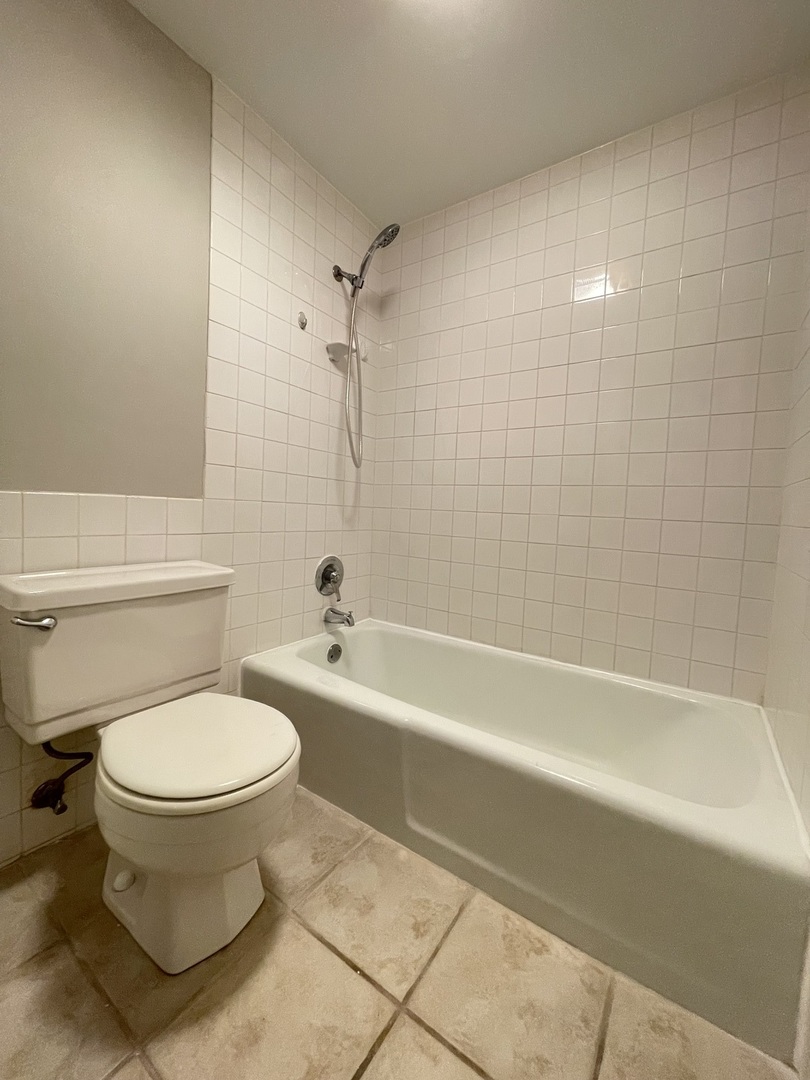 248 East Bailey Road, Unit K Naperville, IL 60565 - Photo 13 of 13 a bathroom with a toilet and a bathtub