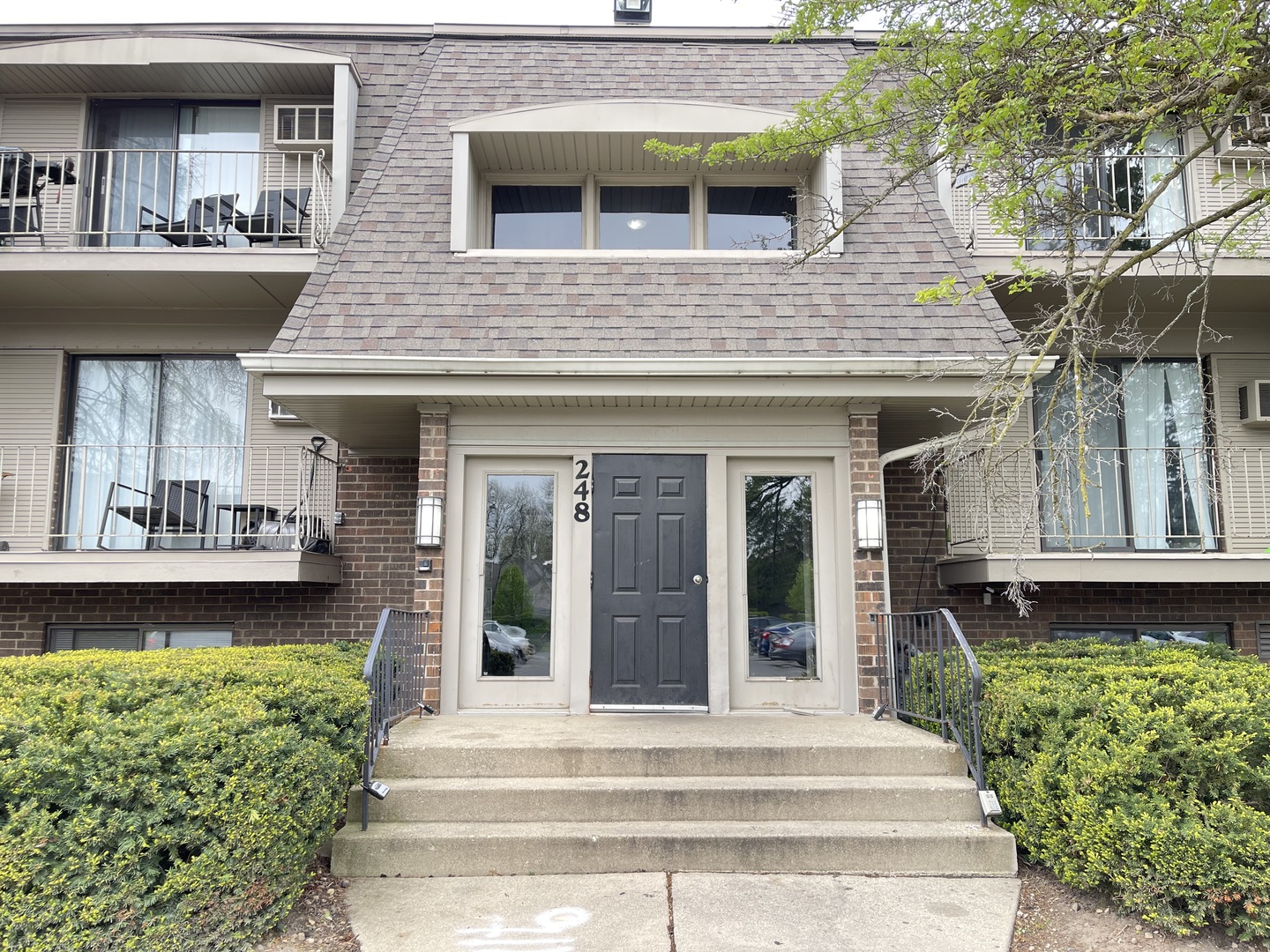 248 East Bailey Road, Unit K Naperville, IL 60565 - Photo 2 of 13 a front view of a house with a yard outdoor seating and garage