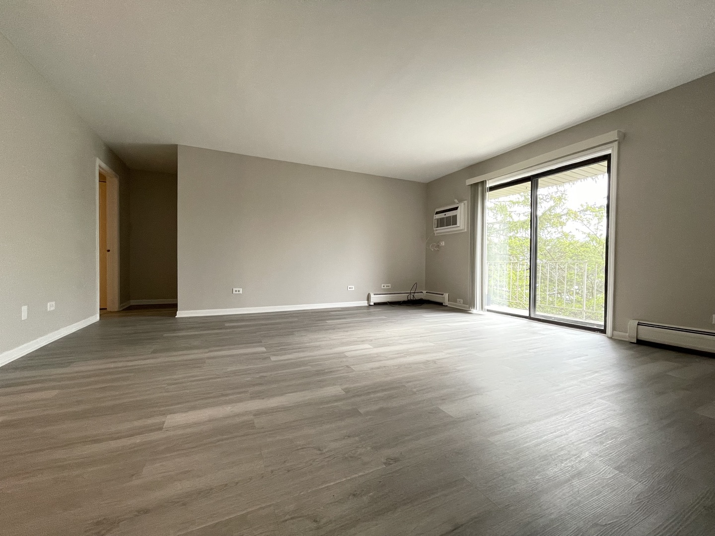 248 East Bailey Road, Unit K Naperville, IL 60565 - Photo 3 of 13 an empty room with wooden floor and windows