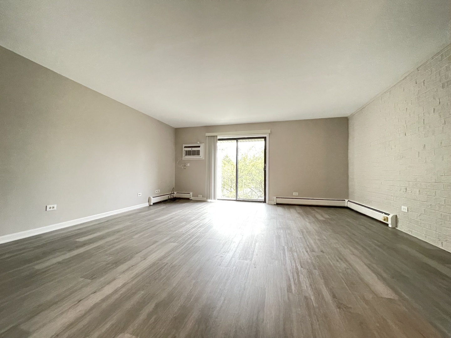 248 East Bailey Road, Unit K Naperville, IL 60565 - Photo 5 of 13 an empty room with wooden floor and windows