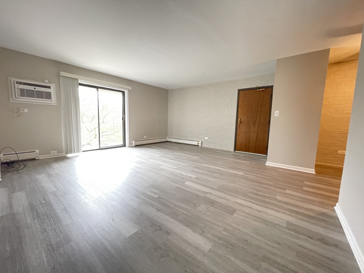 248 East Bailey Road, Unit K Naperville, IL 60565 - Photo 7 of 13 an empty room with wooden floor and windows