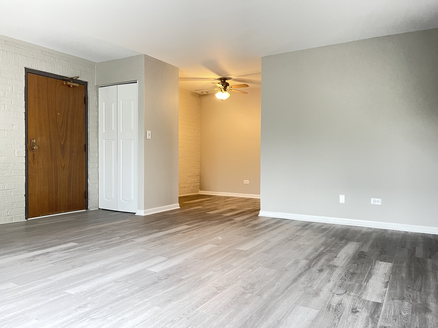 248 East Bailey Road, Unit K Naperville, IL 60565 - Photo 8 of 13 an empty room with wooden floor and a ceiling fan