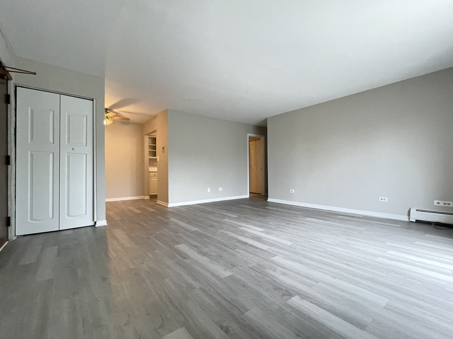 248 East Bailey Road, Unit K Naperville, IL 60565 - Photo 9 of 13 a view of an empty room with wooden floor and a window