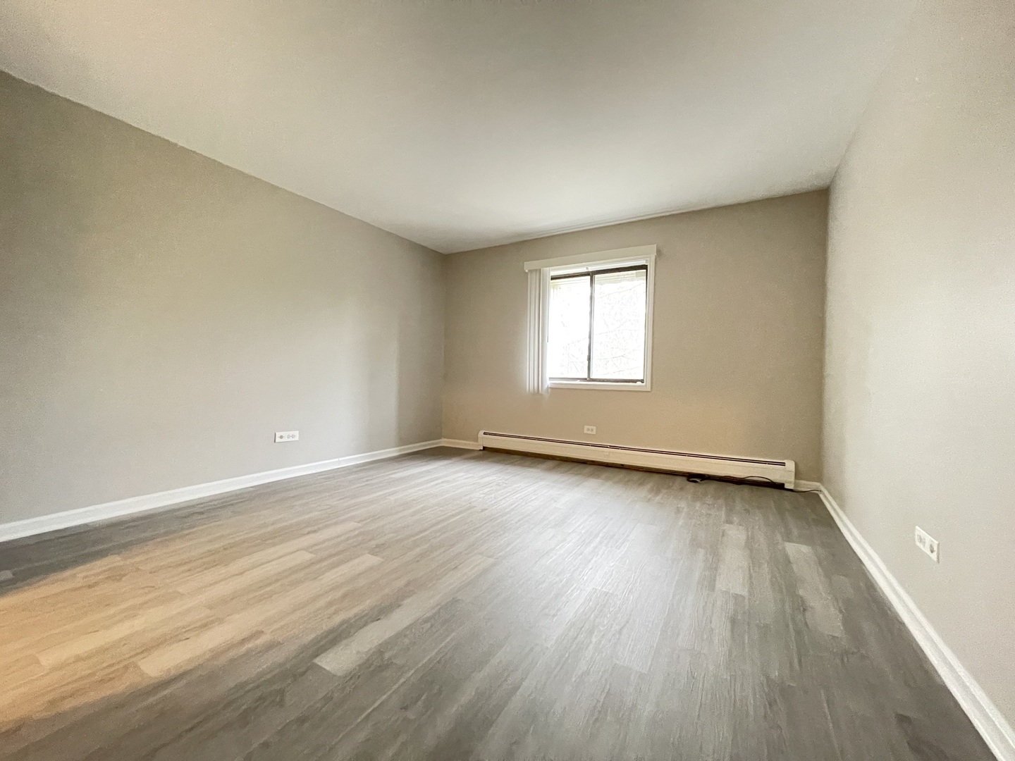 248 East Bailey Road, Unit K Naperville, IL 60565 - Photo 10 of 13 an empty room with wooden floor and windows