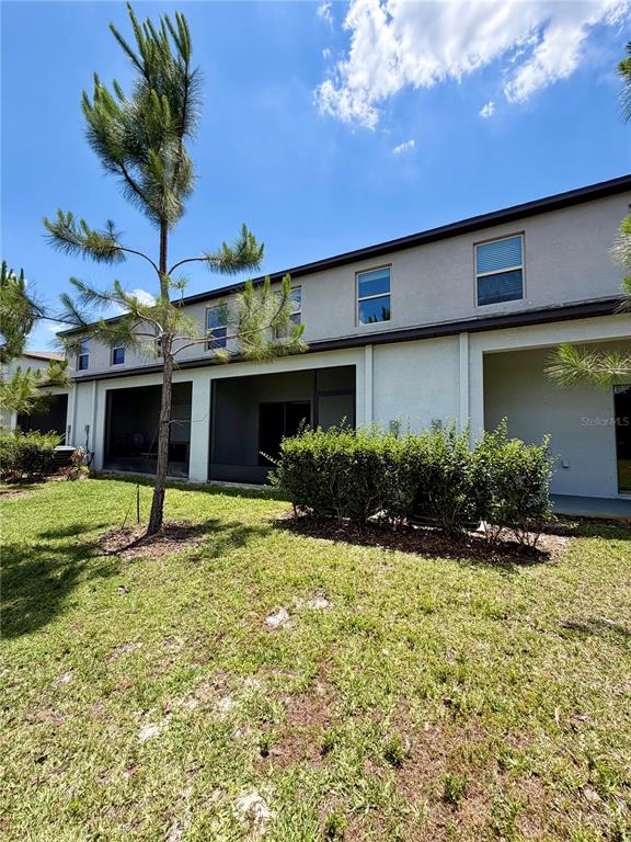 11826 Dumaine Valley Road Riverview, FL 33579 - Photo 36 of 54 a front view of a house with a yard garage and outdoor seating