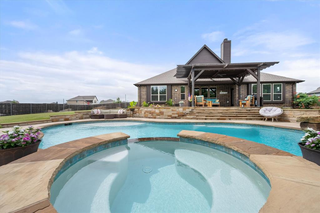 445 Rusty Run Drive Midlothian, TX 76065 - Photo 3 of 40 a swimming pool with outdoor seating and yard in back