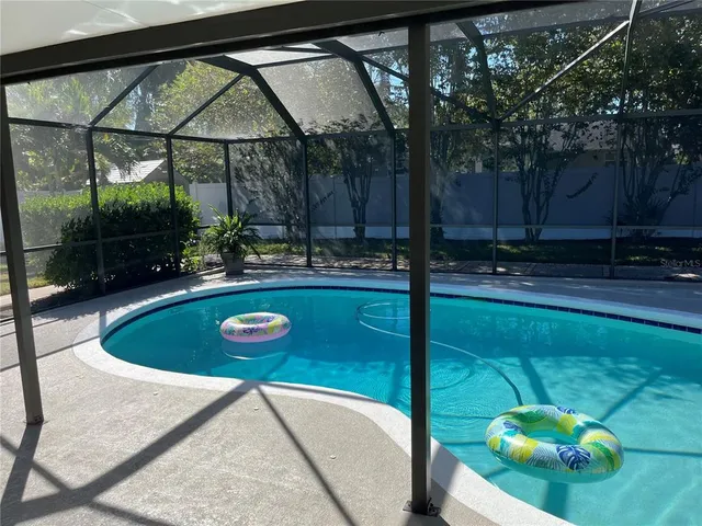 a view of a swimming pool with a yard
