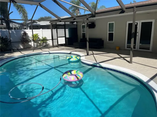 a backyard of a house with table and chairs